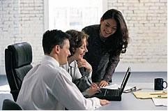 image of people looking at a computer